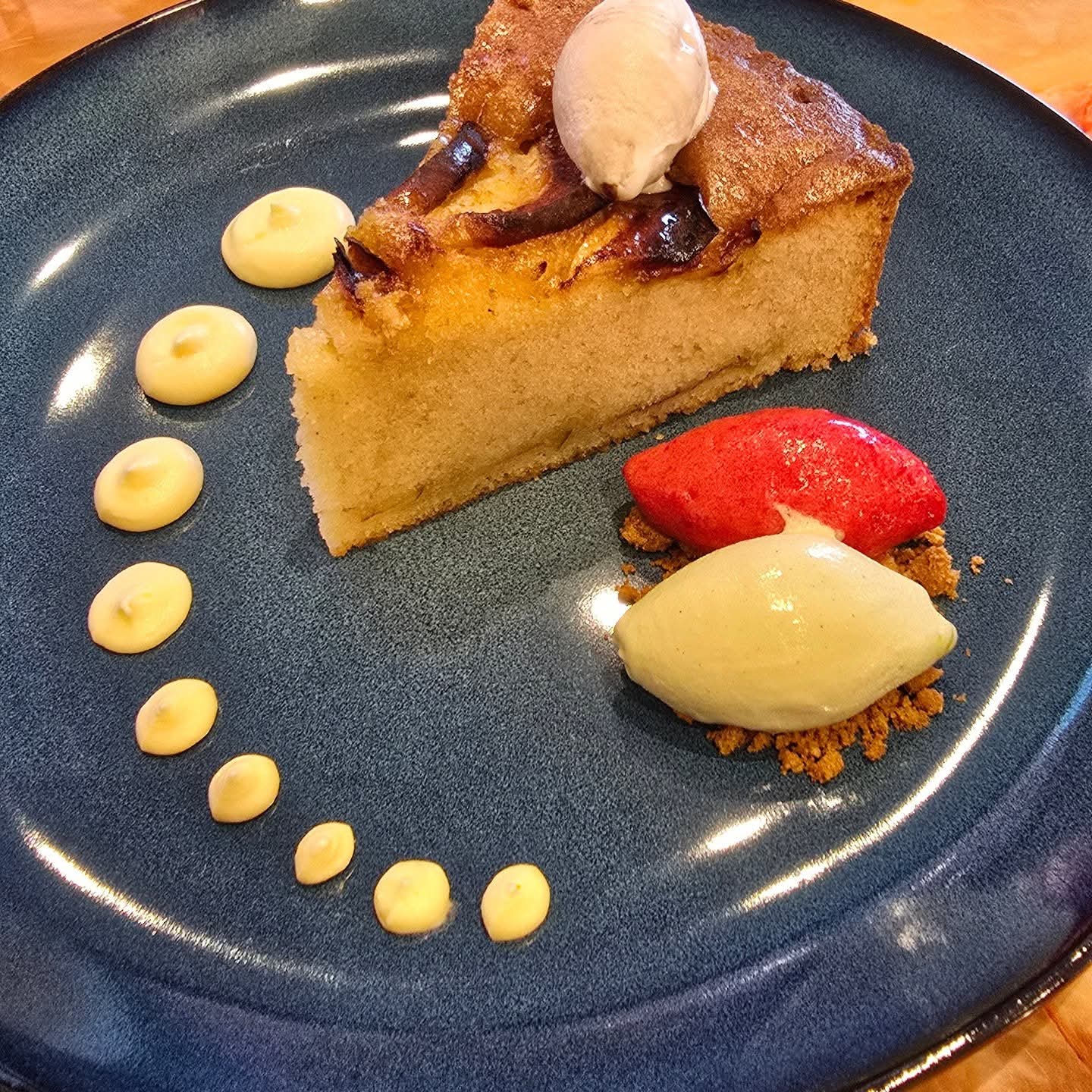 Apple cake slice with sorbet and cream